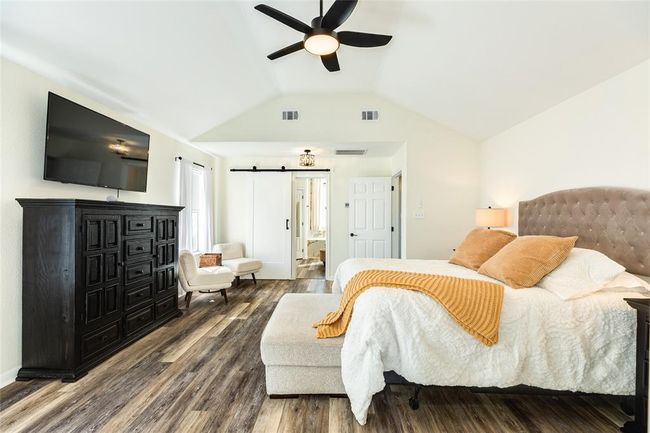 Primary Bedroom has a vaulted ceiling and sliding barn doors | Image 29