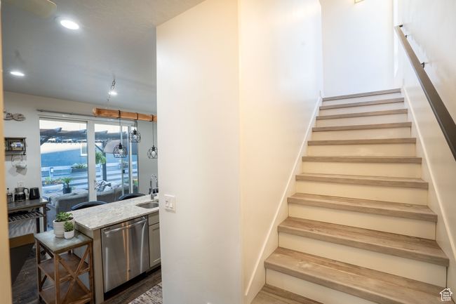 Stairway with recessed lighting and wood finished floors | Image 16