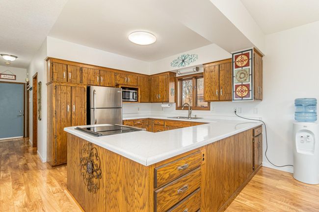 The kitchen features stainless steel appliances and a spacious pantry cupboard. | Image 18