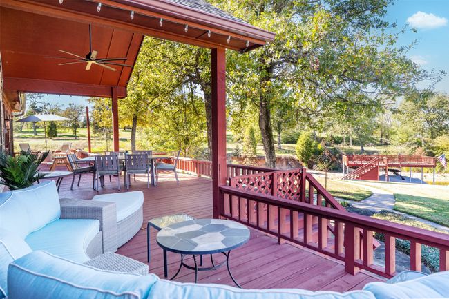 Wooden terrace with ceiling fan and an outdoor living space | Image 26