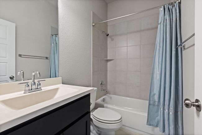 Full bath with combo shower/bath and serves the front private bedroom and office | Image 11