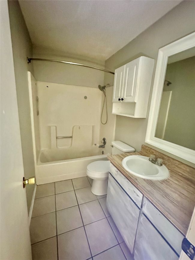 Full bath with vanity, tile patterned floors, and bathing tub / shower combination | Image 18