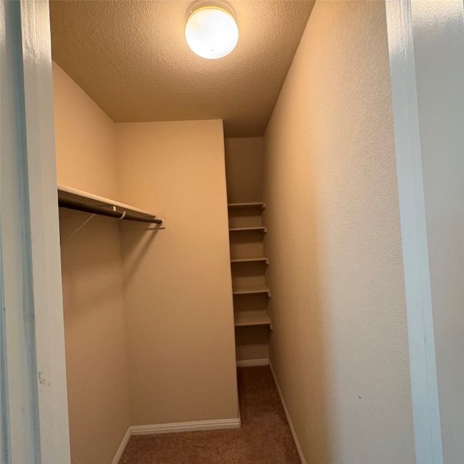 View of spacious closet in primary bedroom | Image 8