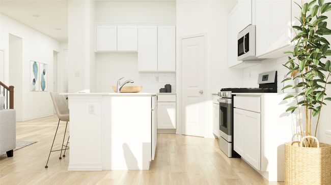 Kitchen featuring gas stove, white microwave, tasteful backsplash, light wood-type flooring, and white cabinetry | Image 12