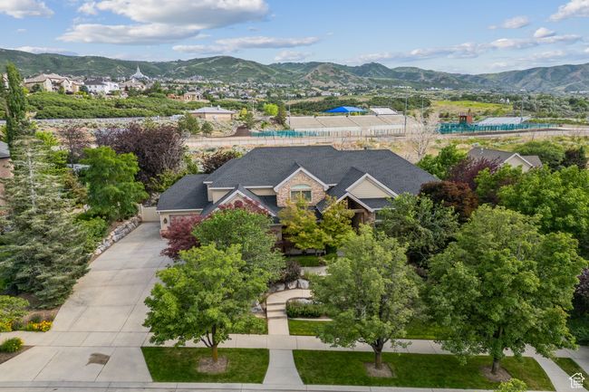Aerial view of property and surrounding area featuring a mountainous background | Image 81