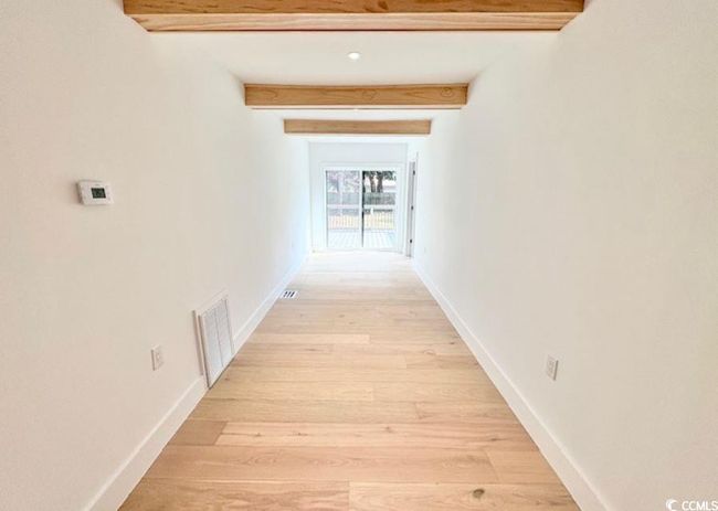 Hallway featuring beam ceiling and light wood-style floors | Image 32