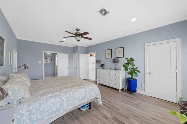 Bedroom with ornamental molding, recessed lighting, ensuite bathroom, light wood-style flooring, and v | Image 17