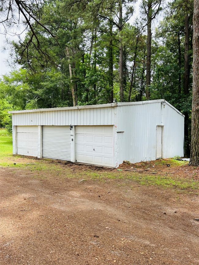 Detached garage with view of scattered trees | Image 9
