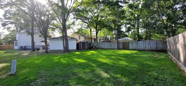 Majestic backyard with a shed behind the 2 car garage | Image 34