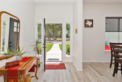 Foyer entrance with light wood-type flooring and a towering ceiling | Image 3