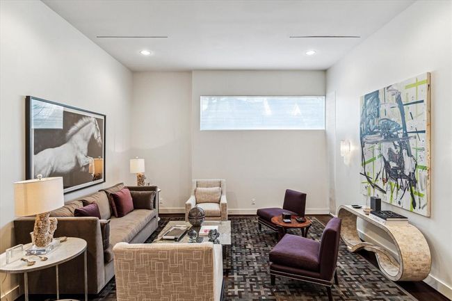 Further privacy, without sacrificing indirect outdoor lighting to filter into the space, is the placement of a large horizontal window at one end of the Living Room. This also allows for additional wall space for art work to be displayed properly. Notice the diffuse ceiling vents adding another touch of modern design to the room. | Image 5