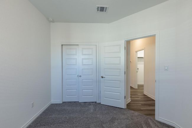 Unfurnished bedroom featuring carpet, visible vents, baseboards, and a closet | Image 20