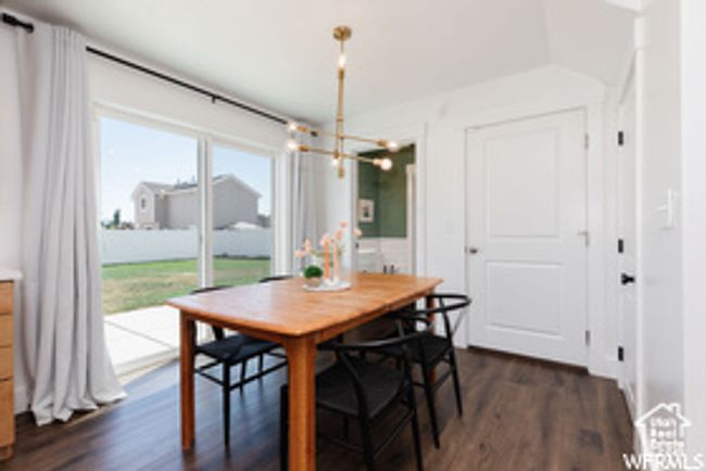 Dining room featuring a chandelier and dark wood-style floors | Image 26
