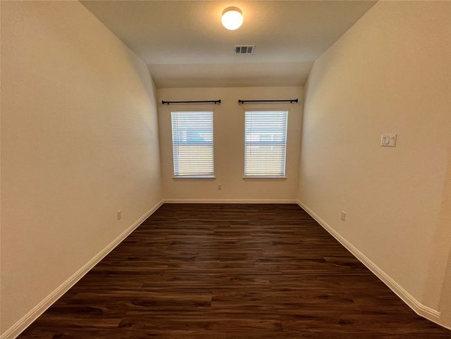 Empty room with dark wood finished floors and vaulted ceiling | Image 28