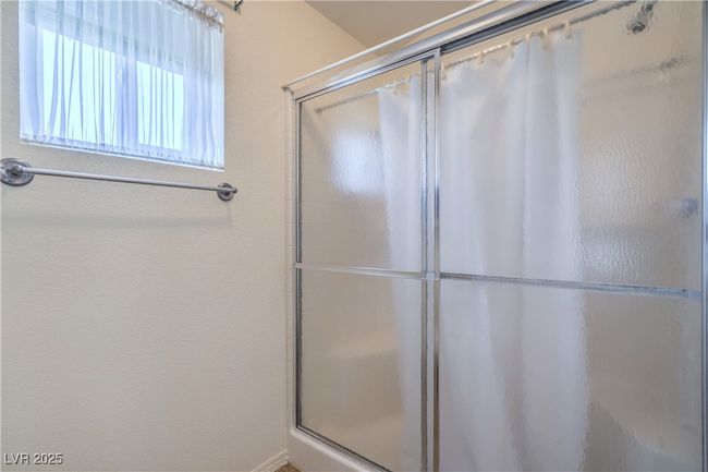 Bathroom with an enclosed shower | Image 20