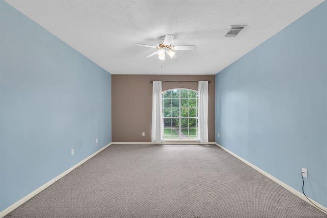 Large bedroom upstairs, window faces the front of the home. | Image 27