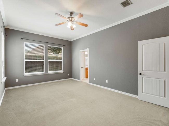 Spare room featuring ceiling fan, light colored carpet, and crown molding | Image 22