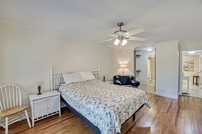 Bedroom with baseboards, light wood-style flooring, ceiling fan, and crown molding | Image 28