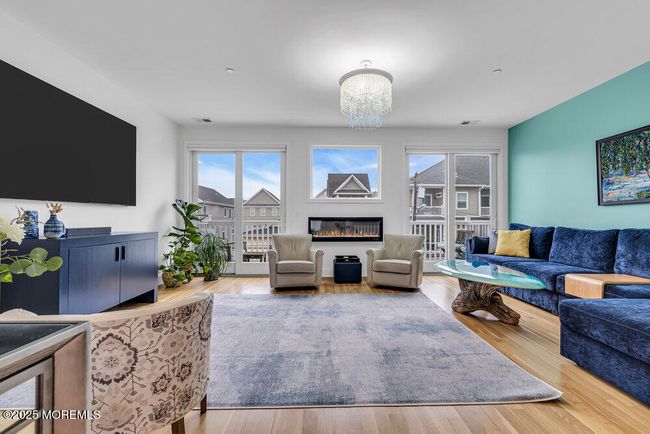 Large Great Room with electric fire place and access to balcony for relaxing | Image 10