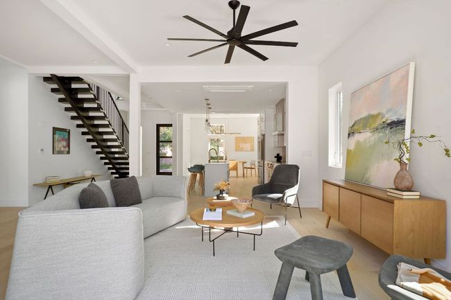 Living room featuring stairway, ceiling fan, baseboards, and light wood-type flooring | Image 5