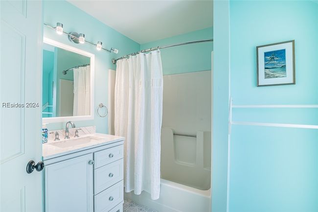 Bathroom with vanity and shower / bath combination with curtain | Image 38