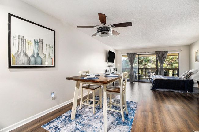 Dining area featuring a textured ceiling, dark wood-style floors, and a ceiling fan | Image 4