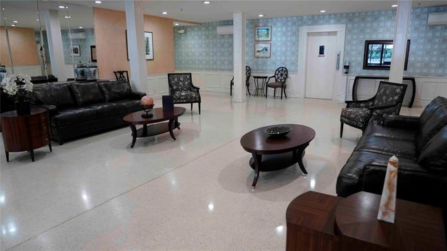 Building lobby featuring wallpapered walls, wainscoting, and a decorative wall | Image 14