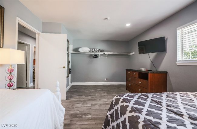 Bedroom with dark wood-type flooring, recessed lighting, and baseboards | Image 43