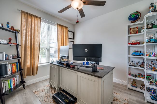 Home office with a ceiling fan, baseboards, and light wood-style flooring | Image 18