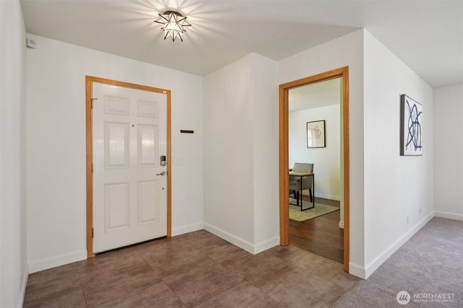 The entry with new vinyl floors, looking into the 3rd bedroom | Image 26