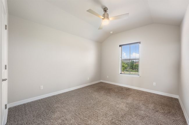 Carpeted spare room with vaulted ceiling and a ceiling fan | Image 27