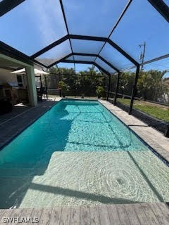 Outdoor pool with a lanai and a patio area | Image 27