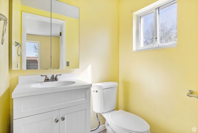 Bathroom featuring a wealth of natural light, vanity, and toilet | Image 33