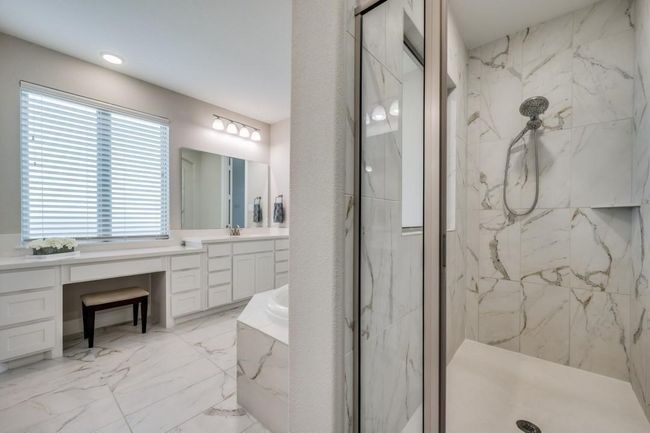 Bathroom featuring a marble finish shower, vanity, a garden tub, and marble finish flooring | Image 22