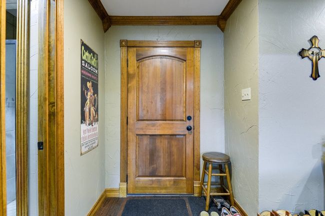 Doorway featuring crown molding and wood finished floors | Image 4