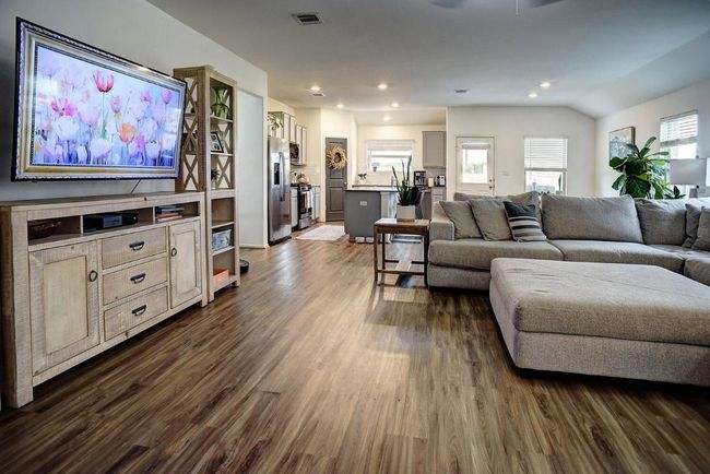 Living room with visible vents, recessed lighting, and dark wood-type flooring | Image 10