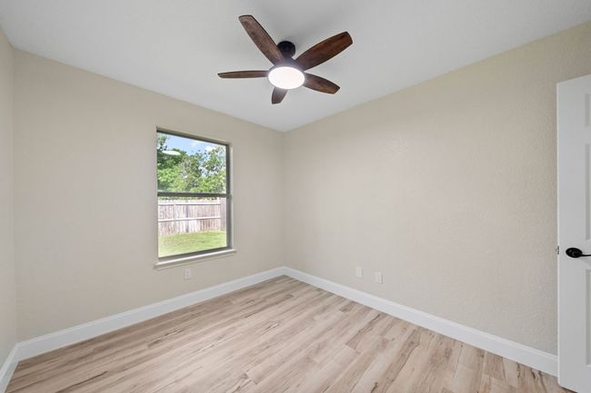 Empty room featuring light wood-type flooring and a ceiling fan | Image 26