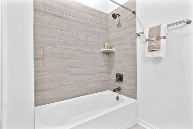 Secondary bedroom features plush carpet, neutral paint, lighting, large window with privacy blinds and ample sized closet space. | Image 7