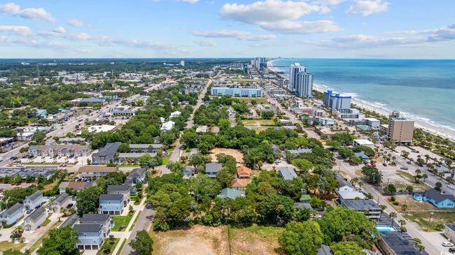 Aerial view of property and surrounding area with a large body of water and nearby urban area | Image 5