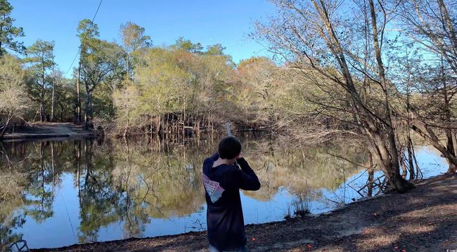 Water view featuring a heavily wooded area | Image 31