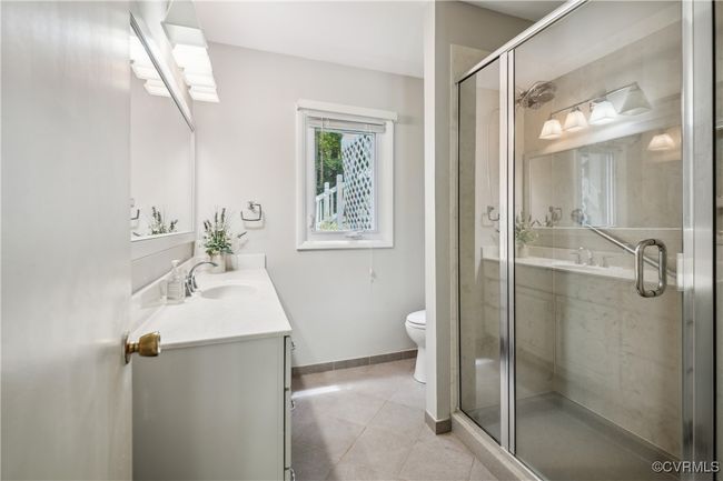 Full bath with vanity, tile patterned flooring, and a stall shower | Image 17