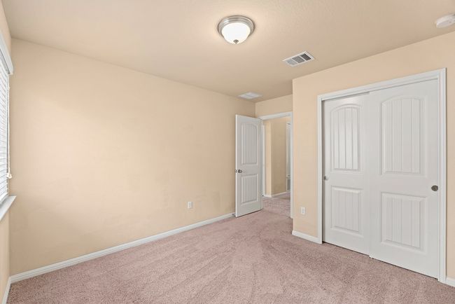 Unfurnished bedroom with a closet, carpet, visible vents, and baseboards | Image 11