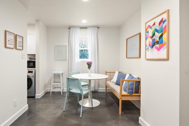 Dining room with washer / clothes dryer, concrete floors, and recessed lighting | Image 10