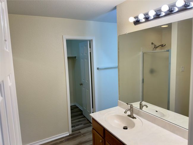 Bathroom featuring wood finished floors, vanity, and a shower | Image 23