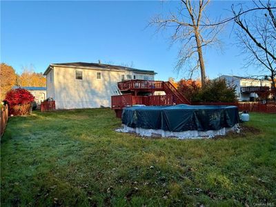 View of yard featuring a wooden deck | Image 2