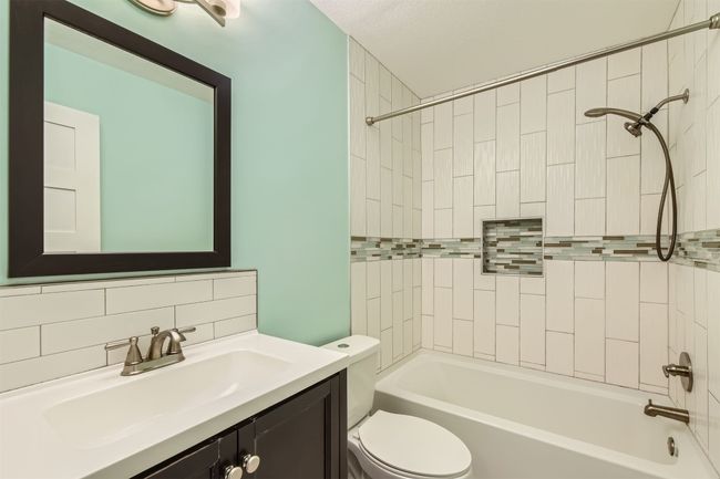 Bathroom featuring vanity, shower / washtub combination, and tasteful backsplash | Image 19