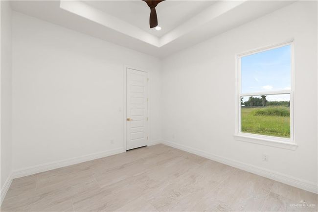 Spacious Secondary Bedrooms with Walk-In ClosetsBoth secondary bedrooms offer generous space, each featuring large walk-in closets and high ceilings that enhance the open, airy feel. | Image 25