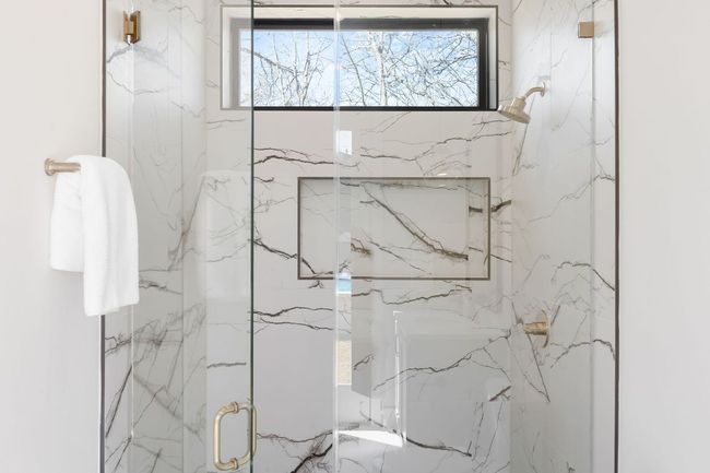 Full bathroom featuring a marble finish shower | Image 35