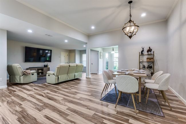 Dining room with wood finished floors, ornamental molding, and recessed lighting | Image 11