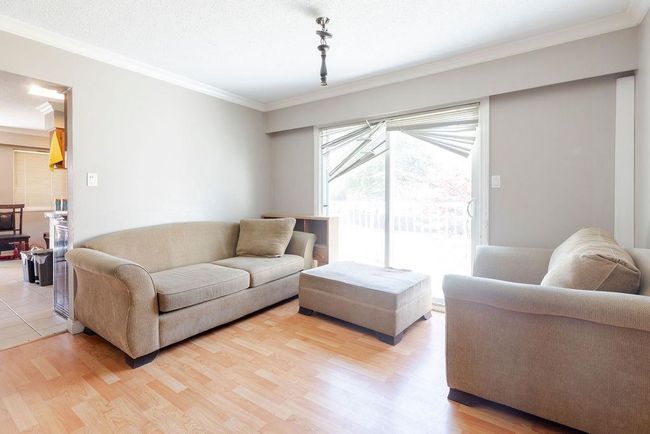 Living room with ornamental molding and light wood finished floors | Image 10